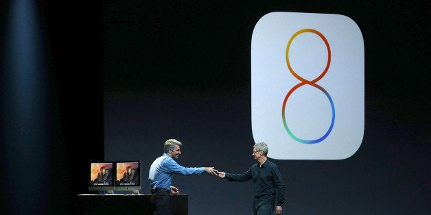 SAN FRANCISCO, CA - JUNE 02: Apple Senior Vice President of Software Engineering Craig Federighi (L) and Apple CEO Tim Cook speak during the Apple Worldwide Developers Conference at the Moscone West center on June 2, 2014 in San Francisco, California. Tim Cook kicked off the annual WWDC which is typically a showcase for upcoming updates to Apple hardware and software. The conference runs through June 6. (Photo by Justin Sullivan/Getty Images)