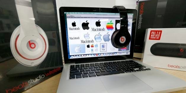 Beats Audio equipment is arranged for a photo next to an Apple laptop at Best Buy in Boston, Friday, May 9, 2014. Apple is orchestrating a $3.2 billion acquisition of Beats Electronics, the headphone maker and music streaming distributor founded by hip-hop star Dr. Dre and record producer Jimmy Iovine, according to a Financial Times report published late Thursday, May 8, 2014. (AP Photo/Michael Dwyer)