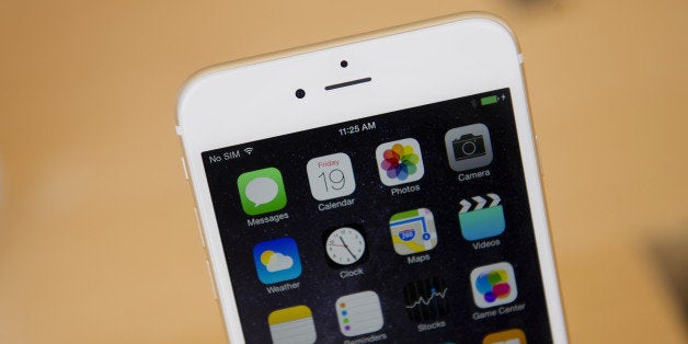 An Apple Inc. iPhone 6 Plus is displayed during the sales launch at an Apple store in Palo Alto, California, U.S., on Friday, Sept. 19, 2014. Apple Inc.'s stores attracted long lines of shoppers for the debut of the latest iPhones, indicating healthy demand for the bigger-screen smartphones. The larger iPhone 6 Plus is already selling out at some stores across the U.S. Photographer: David Paul Morris/Bloomberg via Getty Images