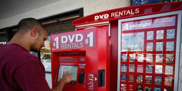 Student Efren Enriquez rents a DVD movie at a Redbox, a $1-per-night DVD movie rental kiosk, outside a 7-Eleven store in Silver Lake area of Los Angeles on Friday, August 7, 2009. Redbox has 17,900 kiosks in the U.S. and expects to add up to 8,500 more this year, nearly one every hour. (AP Photo/Damian Dovarganes)