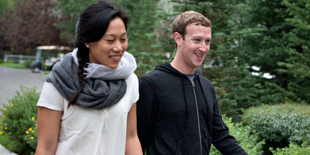 Mark Zuckerberg, chief executive officer and founder of Facebook Inc., walks with his wife Priscilla Chan while arriving for a morning session during the Allen & Co. Media and Technology Conference in Sun Valley, Idaho, U.S., on Thursday, July 11, 2013. Executives from media, finance and politics mingle at the mountain resort between presentations on business trends and social issues, brought together by New York investment banker Herb Allen. Photographer: Daniel Acker/Bloomberg via Getty Images 