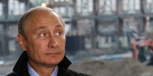 MOSCOW, RUSSIA - OCTOBER 28: Russian President Vladimir Putin observes a reconstruction site of the Luzhniki stadium on October 28, 2014 in Moscow, Russia. The Luzhniki stadium is to become one of the venues of the 2018 FIFA World Cup.(Photo by Sasha Mordovets/Getty Images)