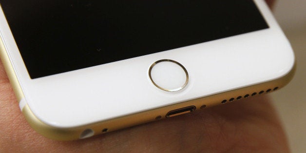 OREM, UT - SEPTEMBER 18: The Touch ID of an Apple iPhone 6 Plus gold, is shown here at a Verizon store on September 18, 2014 in Orem, Utah. Apples new iPhone 6's go on sale tomorrow September 20, 2014. (Photo by George Frey/Getty Images