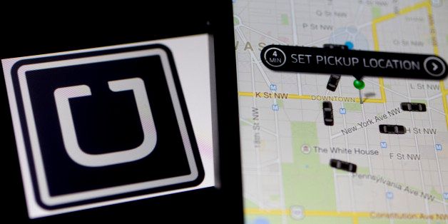 The Uber Technologies Inc. application and logo are displayed on an Apple Inc. iPhone 5s and iPad Air in this arranged photograph in Washington, D.C., U.S., on Wednesday, March 5, 2014. Uber, a startup that lets drivers pick up passengers with their personal cars and that was valued at $3.5 billion in a funding round last year, has raised $307 million from a group of backers that include Google Ventures, Google Inc.'s investment arm, and Jeff Bezos, the founder of Amazon. Photographer: Andrew Harrer/Bloomberg via Getty Images