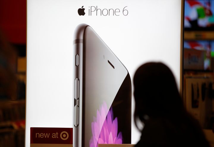 A Target customer looks at the iPhone 6 display on Black Friday, Nov. 28, 2014, in South Portland, Maine. (AP Photo/Robert F. Bukaty)