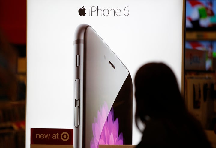 A Target customer looks at the iPhone 6 display on Black Friday, Nov. 28, 2014, in South Portland, Maine. (AP Photo/Robert F.