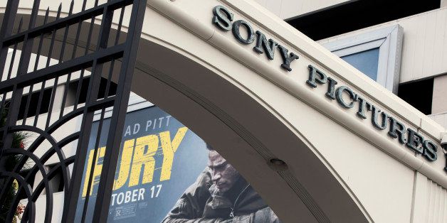 A movie billboard is displayed behind a Sony Pictures Entertainment Studio entrance in Culver City, Calif., Thursday, Dec. 18, 2014. Companies across the globe are on high alert to tighten up network security to avoid being the next company brought to its knees by hackers like those that executed the dramatic cyberattack against Sony Pictures Entertainment. (AP Photo/Damian Dovarganes)