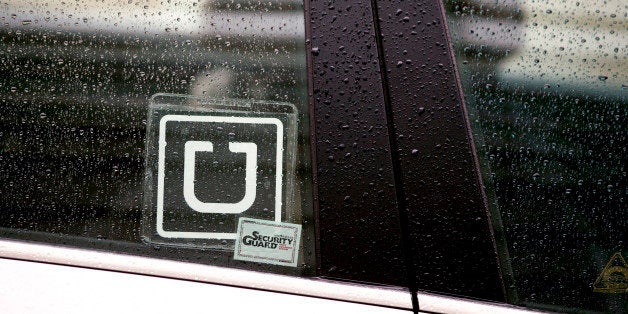 The Uber Technologies Inc. logo is displayed on the window of a vehicle after dropping off a passenger at Ronald Reagan National Airport (DCA) in Washington, D.C., U.S., on Wednesday, Nov. 26, 2014. Uber Technologies Inc. investors are betting the five-year-old car-booking app is more valuable than Twitter Inc. and Hertz Global Holdings Inc. Photographer: Andrew Harrer/Bloomberg via Getty Images