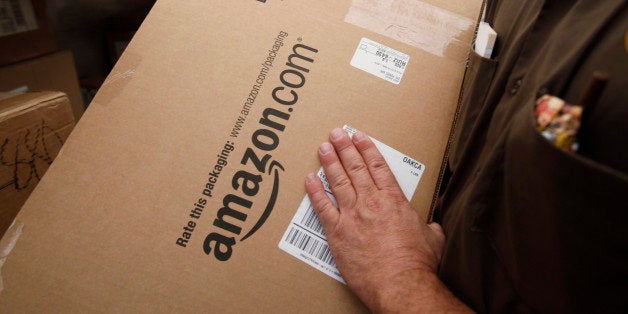 FILE - In this Oct. 18, 2010 file photo, United Parcel Service (UPS) driver Paul Musial lifts an Amazon.com box in Palo Alto,