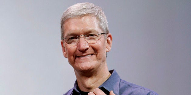 Apple CEO Tim Cook, holding an IPhone 6 Plus, discusses the new Apple Watch and iPhone 6s on Tuesday, Sept. 9, 2014, in Cuper