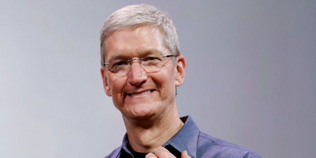 Apple CEO Tim Cook, holding an IPhone 6 Plus, discusses the new Apple Watch and iPhone 6s on Tuesday, Sept. 9, 2014, in Cupertino, Calif. (AP Photo/Marcio Jose Sanchez)