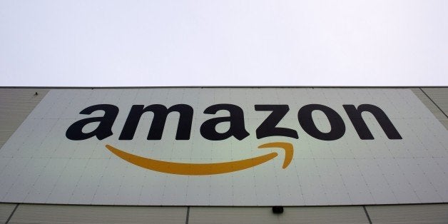 The logo of US online retail giant Amazon is displayed on the Brieselang logistics center, west of Berlin on November 11, 201
