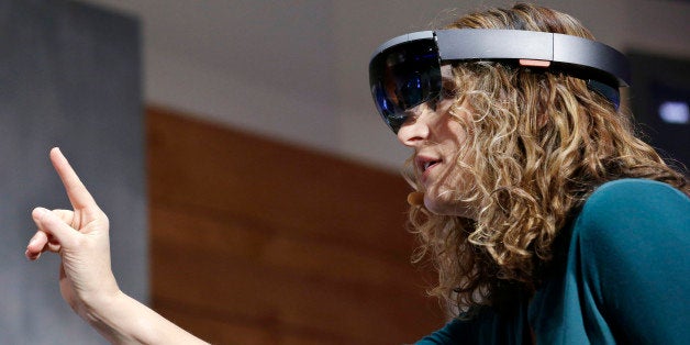 In this Jan. 21, 2015 photo, Microsoft's Lorraine Bardeen demonstrates HoloLens headset during an event at the company's head