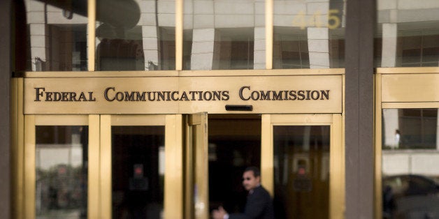 A man walks into the Federal Communications Commission (FCC) headquarters in this photo taken with a tilt-shift lens in Washington, D.C., U.S., on Monday, Nov. 10, 2014. President Barack Obama called for the 'strongest possible rules' to protect the open Internet, advocating stricter controls than a regulator he appointed and causing shares of Comcast Corp. and other broadband providers to drop. Obama's comments tilt the White House against positions advocated by broadband providers and FCC Chairman Tom Wheeler. Photographer: Andrew Harrer/Bloomberg via Getty Images