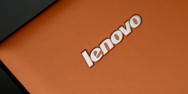 A Lenovo Group Ltd. logo is displayed on a IdeaPad Yogo 2 Pro as it sits on display in this arranged photograph at a Lenovo s