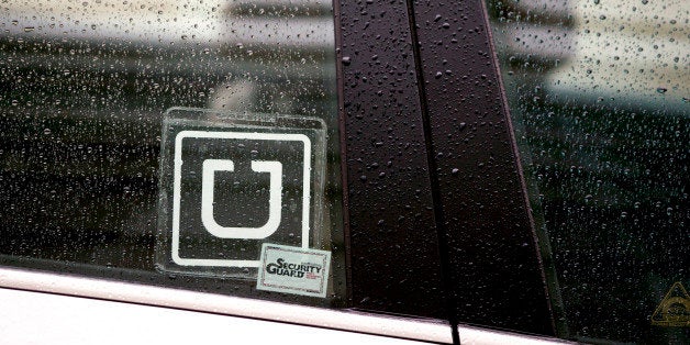 The Uber Technologies Inc. logo is displayed on the window of a vehicle after dropping off a passenger at Ronald Reagan National Airport (DCA) in Washington, D.C., U.S., on Wednesday, Nov. 26, 2014. Uber Technologies Inc. investors are betting the five-year-old car-booking app is more valuable than Twitter Inc. and Hertz Global Holdings Inc. Photographer: Andrew Harrer/Bloomberg via Getty Images