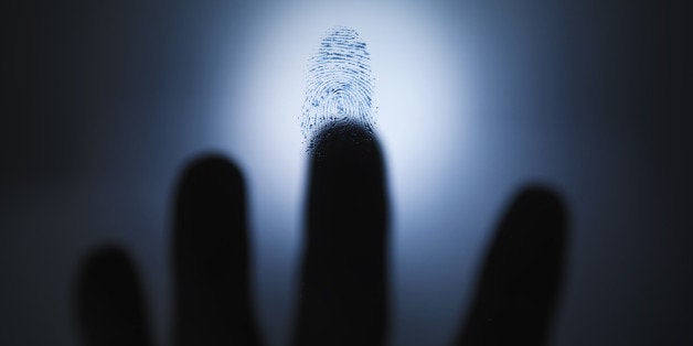 Blurred hand hovering over fingerprint