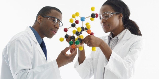 Laboratory technicians studying molecular model