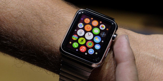 An attendee demonstrates the Apple Watch after a product announcement at Flint Center in Cupertino, California, U.S., on Tuesday, Sept. 9, 2014. Apple Inc. unveiled redesigned iPhones with bigger screens, overhauling its top-selling product in an event that gives the clearest sign yet of the company's product direction under Chief Executive Officer Tim Cook. Photographer: David Paul Morris/Bloomberg via Getty Images