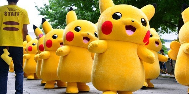 Dozens of Pikachu characters, the famous character of Nintendo's videogame software Pokemon, parade at the Landmark Plaza shopping mall in Yokohama, suburban Tokyo on August 14, 2014. The Pikachu mascots walk around daily to attract summer vacationers as a part of the 'Great Pikachu Outbreak' event through the weekend. AFP PHOTO / Yoshikazu TSUNO (Photo credit should read YOSHIKAZU TSUNO/AFP/Getty Images)