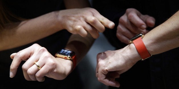 Members of the media and Apple guests get to review the new Apple Watch in the demo room after the Apple event on Monday, March 9, 2015, in San Francisco. (AP Photo/Eric Risberg)