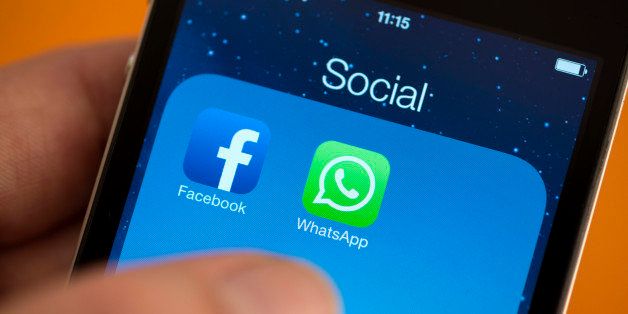 BERLIN, GERMANY - FEBRUARY 25: Facebook next to the WhatsApp logo on iPhone hold by a hand. on February 25, 2014 in Berlin, Germany. (Photo by Marie Waldmann/Photothek via Getty Images)