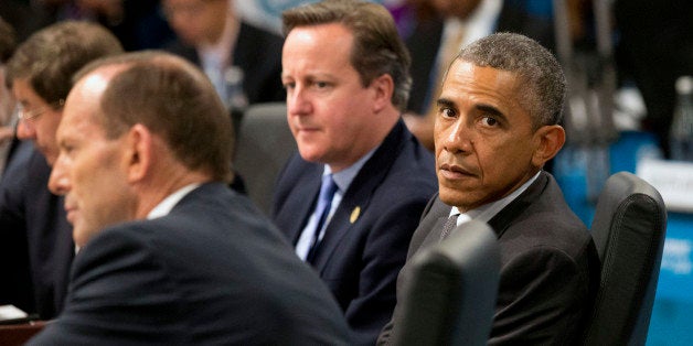 U.S. President Barack Obama, right, looks away as Prime Minister of Australia Tony Abbott, left, address a plenary session wh