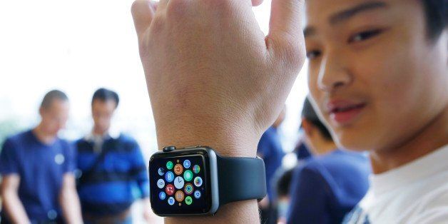 A customer tries on an Apple Watch at an Apple Store in Hong Kong Friday, April 10, 2015. From Beijing to Paris to San Francisco, the Apple Watch made its debut Friday. Customers were invited to try them on in stores and order them online. (AP Photo/Kin Cheung)