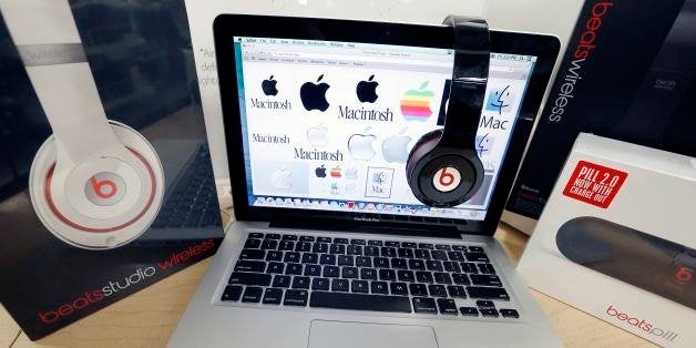 FILE - In this May 9, 2014 file photo, Beats Audio equipment is arranged for a photo next to an Apple laptop at Best Buy in Boston. Apple announced Wednesday, May 28, 2014, that it is acquiring Beats Electronics for $3 billion. Beats, the headphone and music streaming specialist, also brings the swagger of rapper Dr. Dre and recording impresario Jimmy Iovine. (AP Photo/Michael Dwyer, File)