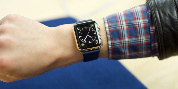 An excited customer tries on the Apple Watch Edition at the Eaton Centre Apple Store on Friday, April 10, 2015 in Toronto. (Photo by Ryan Emberley/Invision for Apple/AP Images)