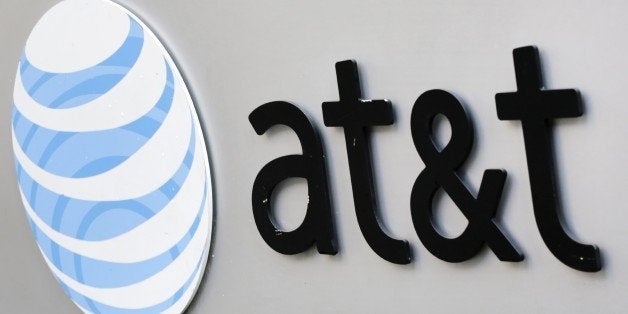 The corporate logo for AT&T is shown on the outside of one of its New York facilities, Tuesday, April 21, 2015. (AP Photo/Mark Lennihan)