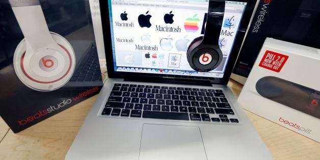 FILE - In this May 9, 2014 file photo, Beats Audio equipment is arranged for a photo next to an Apple laptop at Best Buy in Boston. Apple announced Wednesday, May 28, 2014, that it is acquiring Beats Electronics for $3 billion. Beats, the headphone and music streaming specialist, also brings the swagger of rapper Dr. Dre and recording impresario Jimmy Iovine. (AP Photo/Michael Dwyer, File)