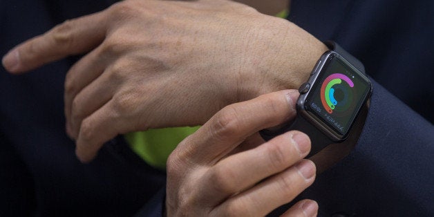 TOKYO, JAPAN - APRIL 24: A customer tries on an Apple Watch at a store on April 24, 2015 in Tokyo, Japan. The Apple Watch launched globally today after months of publicity and pre-orders. However the smart watch was not sold from Apple stores but from a handful of upscale boutiques at select locations around the world in a bid to position the watch as a fashion accessory. Apple has been directing people to order online preventing the long lines usual seen with the launch of iPhones and iPads. (Photo by Chris McGrath/Getty Images)