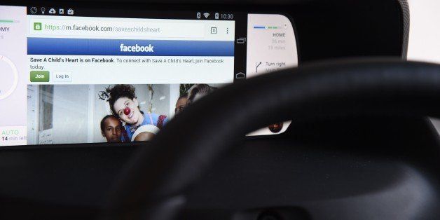 Facebook from a wirelessly connected smartphone is seen on the mockup display of Valeo's Mobi/us autonomous dashboard, a concept for interacting with a self-driving car as well as with one's smartphone, January 6, 2015 at the Consumer Electronics Show in Las Vegas, Nevada. When the car is driving in autopilot mode the driver can watch movies or surf the web on his wirelessly connected smartphone. Depending on the linked smartphone, either Chromecast, Miracast or Apple's AirPlay can be used to wirelessly display and operate the smartdevice. Mobi/us also allows the driver to switch between traditional driving and automonous driving and monitors the driver's hands and eyes to determine that the driver is ready to drive the car manually when instructed by Mobi/us to do so. AFP PHOTO / ROBYN BECK (Photo credit should read ROBYN BECK/AFP/Getty Images)