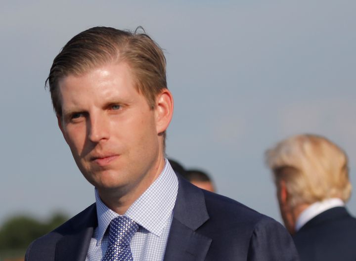 Eric Trump is seen with his father, President Donald Trump, in August 2017. The president's son reportedly helped him cover up an alleged affair.