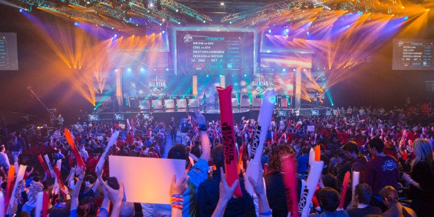 FILE - In this May 11, 2014 file photo, fans watch the opening ceremony of the League of Legends season 4 World Championship Final between South Korea against China's Royal Club, in Paris. With millions of gamers now regularly spectating video games online and in arenas, game developers are angling to learn a few lessons from esports and possibly create the next "League of Legends" at this year's Game Developers Conference, the annual gathering of video game creators, kicking-off Monday, March 2, 2015, through Friday. A survey by GDC organizers of more than 200,000 developers found that 79 percent believe competitive gaming is now a sustainable business model. (AP Photo/Jacques Brinon, File)