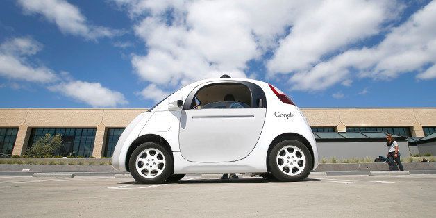 In this May 13, 2015 photo, Google's new self-driving prototype car is presented during a demonstration at the Google campus in Mountain View, Calif. The car, which needs no gas pedal or steering wheel, will make its debut on public roads this summer. (AP Photo/Tony Avelar)