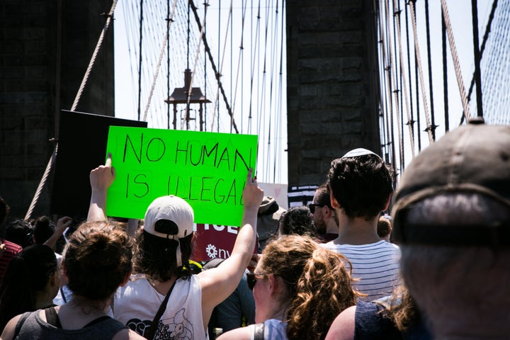 A demonstrator holds a sign reading "No Human Is Illegal" during a protest against President Trump's immigration policies in New York, New York on June 30, 2018. 