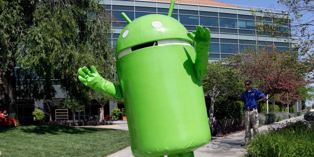 A person costumed as the Android operating system mascot greets visitors at Google headquarters in Mountain View, Calif., Thu