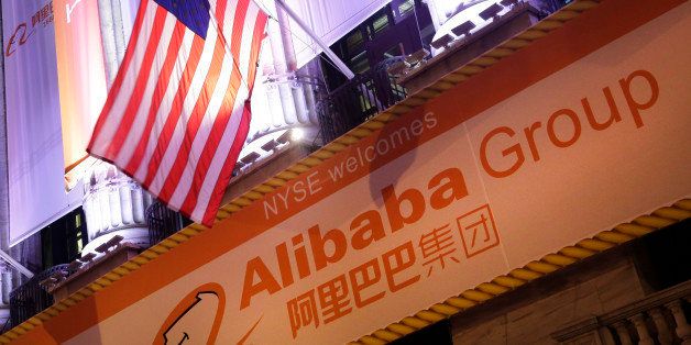 An American flag waves over a banner for Alibaba on the New York Stock Exchange, Friday, Sept. 19, 2014 in New York. The stock is expected to start trading Friday under the ticker "BABA." The IPO values Alibaba at $167.62 billion, larger than the current market value of Amazon, Cisco, and eBay. (AP Photo/Mark Lennihan)