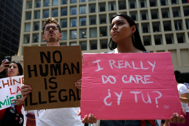 A demonstrator holds a sign reading "No Human Is Illegal" during a protest in Chicago in June against Immigration and Customs Enforcement (ICE) and the Trump administration's immigration policies.