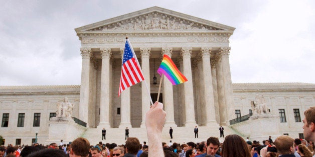 The crowd celebrates outside of the Supreme Court in Washington, Friday June 26, 2015, after the court declared that same-sex couples have a right to marry anywhere in the US. (AP Photo/Jacquelyn Martin)