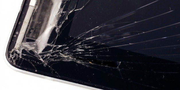 An iPad has a cracked screen in this studio photo, Friday, Dec. 6, 2013 in New York. Many device protection plans can be star