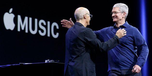 Apple CEO Tim Cook, right, hugs Beats by Dre co-founder and Apple employee Jimmy Iovine at the Apple Worldwide Developers Conference in San Francisco, Monday, June 8, 2015. The maker of iPods and iPhones announced Apple Music, an app that combines a 24-hour, seven-day live radio station called "Beats 1" with an on-demand music streaming service. (AP Photo/Jeff Chiu)