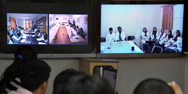 TO GO WITH Afghanistan-Health-Technology by Joris FioritiNurses from The French Medical Institute for Children speak to colleagues in other regions via a 'tele-conference link' in Kabul on May 13, 2012. Telemedicine is being used in Kabul to help curing children from remote areas in the northeastern and central part of Afghanistan. More than 5500 consultations have been done this way, saving many lives. AFP PHOTO/Bay ISMOYO (Photo credit should read BAY ISMOYO/AFP/Getty Images)