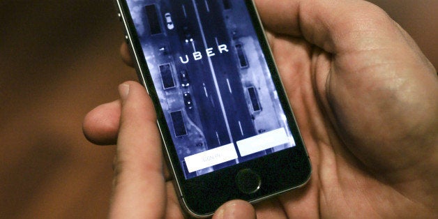 Anthony Khoury, head of Middle East and Africa expansions for Uber, uses the mobile application at a press event to celebrate