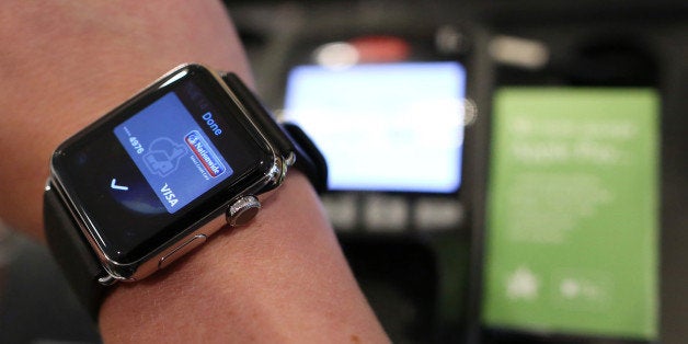 A customer uses an Apple Inc. Apple Watch to pay via the Apple Pay system, from their Nationwide account, at the check-out till inside a Pret A Manger Ltd store in this arranged photograph in London, U.K., on Tuesday, July 14, 2015. Apple Inc. is making the U.K. the first market outside the U.S. for its digital-wallet system as the company fights for a place in the electronic-payments industry. Photographer: Chris Ratcliffe/Bloomberg via Getty Images