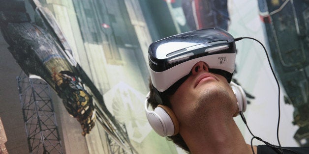 BERLIN, GERMANY - SEPTEMBER 05: A visitor tries out Gear VR virtual reality goggles amd headphones at the Samsung stand at the 2014 IFA home electronics and appliances trade fair on September 5, 2014 in Berlin, Germany. IFA is the world's biggest fair of its kind and is open to the public through September 10. (Photo by Sean Gallup/Getty Images)