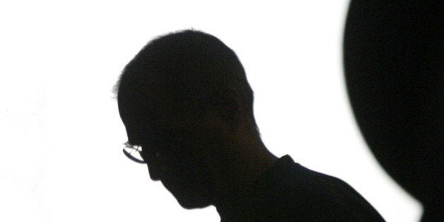 Apple Computer Inc. chief executive Steve Jobs is silhouetted in the Apple logo at the Moscone Center in San Francisco, Monda