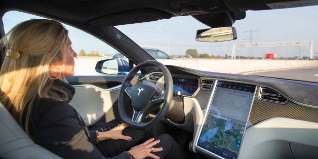 An employee drives a Tesla Motors Inc. Model S electric automobile, equipped with Autopilot hardware and software, hands-free